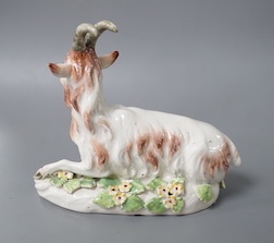 A rare Derby figure of a goat, naturalistically painted, recumbent on a scroll moulded base, c.1758-60, patch marks 12cm